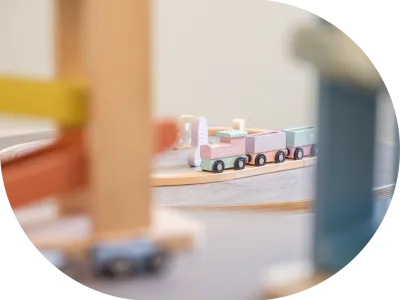 a toy train on a wooden track in a circle