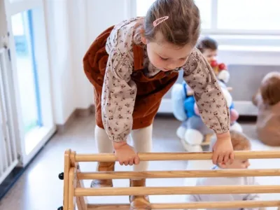 peuter klimt binnen op een klimtoestel op het kinderdagverblijf van Impuls
