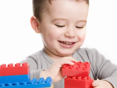 Smiling boy playing with his blocks