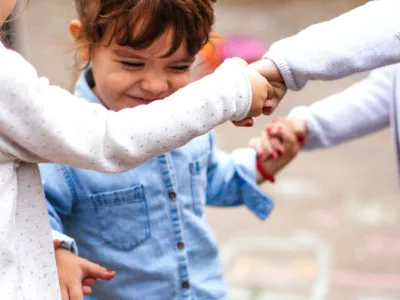 Toddler friends playing hopscotch outdoors