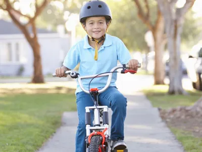 Boy Wearing Safety Helmet Riding Bike