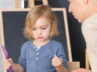 Little girl having fun at school during art classes