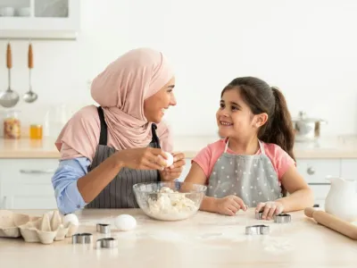 Leisure With Mom. Happy Muslim Mother And Little Daughter Baking In Kitchen
