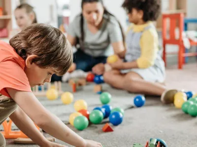 Children interacting with toys in a vibrant kindergarten setting, focusing on creativity and learning.
