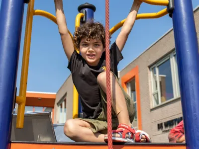 Jongen op klimrek bij BSO